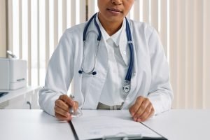 Female doctor writing sick note